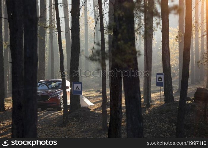 travel by car. car and tent on the background of signs place for camping