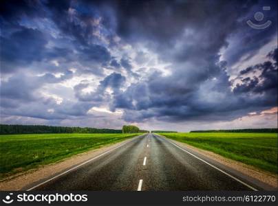 Travel concept background - road and stormy dramatic sky. Road and stormy sky