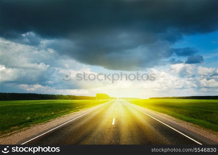 Travel concept background - road and stormy sky