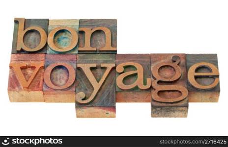 travel concept - bon voyage phrase in vintage wooden letterpress printing blocks, stained by color inks, isolated on white