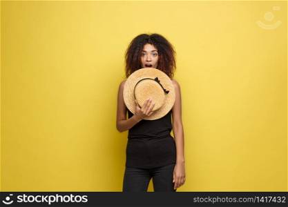 Travel concept - Close up Portrait young beautiful attractive African American woman with trendy hat smiling and joyful expression. Yellow Pastel studio Background. Copy space. Travel concept - Close up Portrait young beautiful attractive African American woman with trendy hat smiling and joyful expression. Yellow Pastel studio Background. Copy space.