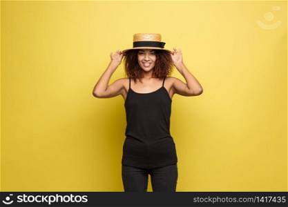 Travel concept - Close up Portrait young beautiful attractive African American woman with trendy hat smiling and joyful expression. Yellow Pastel studio Background. Copy space. Travel concept - Close up Portrait young beautiful attractive African American woman with trendy hat smiling and joyful expression. Yellow Pastel studio Background. Copy space.