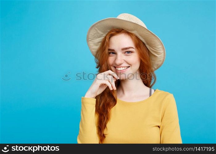 Travel concept - Close up Portrait young beautiful attractive redhair girl with trendy hat and smiling. Blue Pastel Background. Copy space.