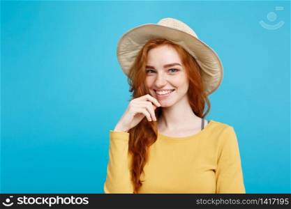 Travel concept - Close up Portrait young beautiful attractive redhair girl with trendy hat and smiling. Blue Pastel Background. Copy space.