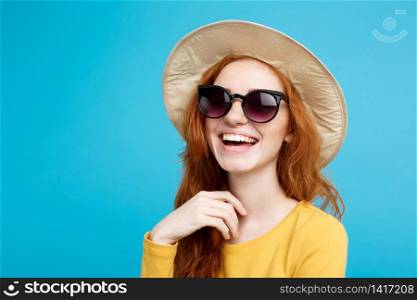 Travel concept - Close up Portrait young beautiful attractive redhair girl wtih trendy hat and sunglass smiling. Blue Pastel Background. Copy space.. Travel concept - Close up Portrait young beautiful attractive redhair girl with trendy hat and sunglass smiling. Blue Pastel Background. Copy space.