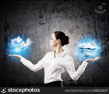 Travel concept. Image of businesswoman holding items in palms. Making choice