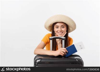Travel concept. Studio portrait of pretty young woman holding passport and luggage. Isolated on white.. Travel concept. Studio portrait of pretty young woman holding passport and luggage. Isolated on white