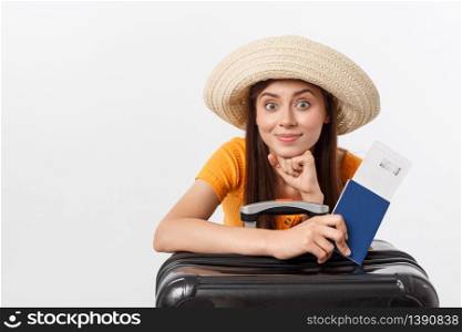 Travel concept. Studio portrait of pretty young woman holding passport and luggage. Isolated on white.. Travel concept. Studio portrait of pretty young woman holding passport and luggage. Isolated on white