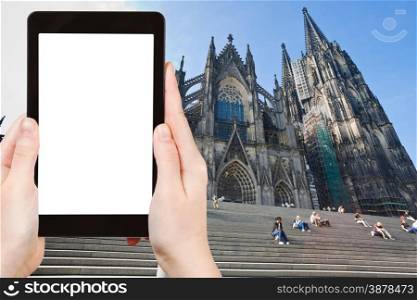 travel concept - tourist photograph Cologne Cathedral, Gernany on tablet pc with cut out screen with blank place for advertising logo