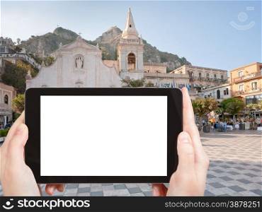 travel concept - tourist photograph Piazza IX Aprile near Chiesa di san Giuseppe, in Taormina, Sicily, Italy on tablet pc with cut out screen with blank place for advertising logo