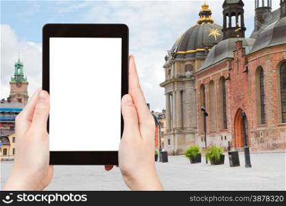 travel concept - tourist photograph square (Birger Jarls Torg) near Riddarholmskyrkan (Knights church) in Stockholm, Sweden on tablet pc with cut out screen with blank place for advertising logo