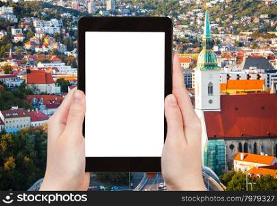 travel concept - tourist photographs Bratislava old town on tablet pc with cut out screen with blank place for advertising logo