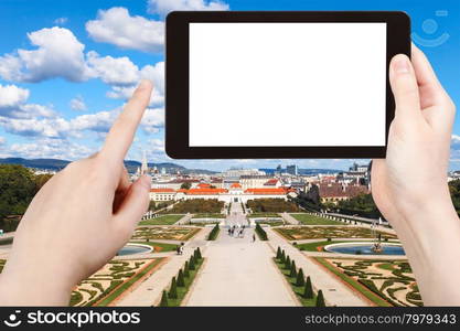 travel concept - tourist photographs garden of Belvedere Palace in Vienna on tablet pc with cut out screen with blank place for advertising logo