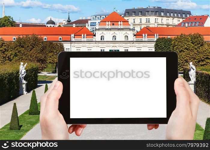 travel concept - tourist photographs Lower Belvedere Palace in Vienna on tablet pc with cut out screen with blank place for advertising logo
