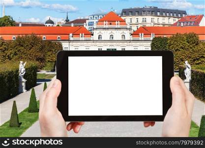 travel concept - tourist photographs Lower Belvedere Palace in Vienna on tablet pc with cut out screen with blank place for advertising logo