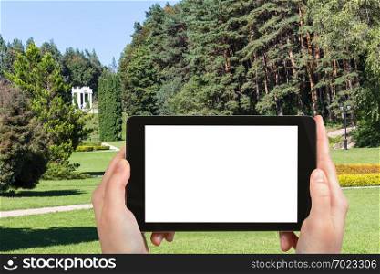 travel concept - tourist photographs of Kislovodsk National Park in Caucasian Mineral Waters region of Russia in september smartphone with cut out screen with blank place for advertising