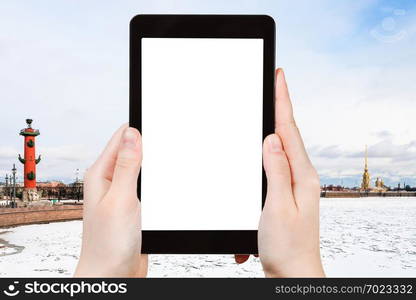 travel concept - tourist photographs of Spit of Vasilyevsky Island with Rostral Column and Peter and Paul Fortress in Saint Petersburg on smartphone with cutout screen with blank place for advertising