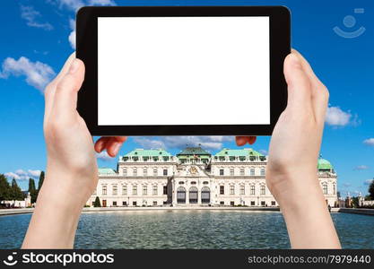 travel concept - tourist photographs Upper Belvedere Palace in Vienna on tablet pc with cut out screen with blank place for advertising logo