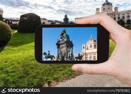 travel concept - tourist snapshot of Empress Maria Theresa statue on Maria Theresien square in Vienna on smartphone