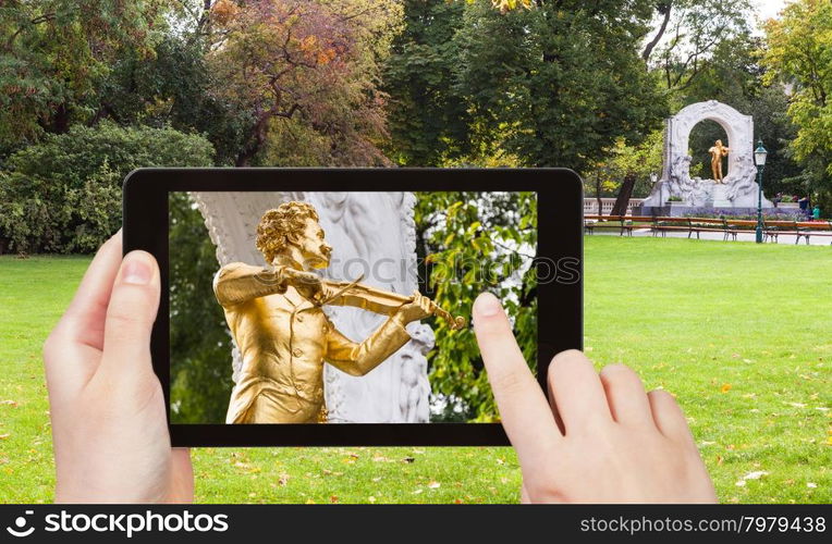 travel concept - tourist snapshot of monument of Johann Strauss son in Stadtpark (City Park) in Vienna on tablet pc