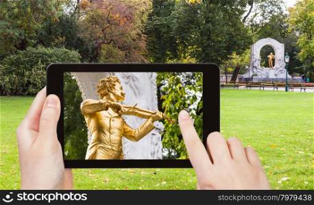 travel concept - tourist snapshot of monument of Johann Strauss son in Stadtpark (City Park) in Vienna on tablet pc