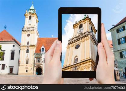 travel concept - tourist snapshot of Old Town Hall at Main Square in Bratislava on tablet pc