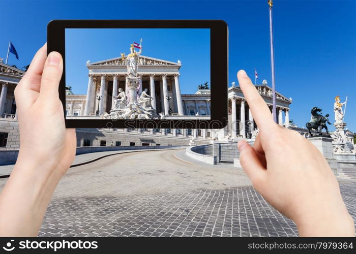 travel concept - tourist snapshot of Pallas Athena Fountain and Austrian Parliament Building in Vienna on tablet pc