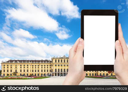 travel concept - tourist take photo of Schloss Schonbrunn palace in Vienna on tablet pc with cut out screen with blank place for advertising logo