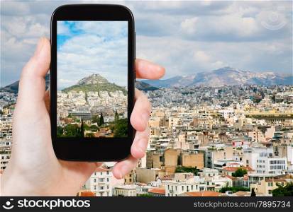 travel concept - tourist taking photo of Athens city skyline on mobile gadget, Greece