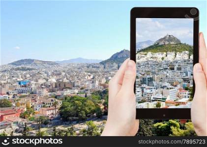 travel concept - tourist taking photo of Athens cityscape on mobile gadget, Greece