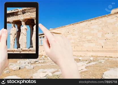 travel concept - tourist taking photo of caryatids at acropolis on mobile gadget, Athens, Greece