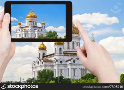 travel concept - tourist taking photo of Cathedral of Christ the Saviour, Moscow on mobile gadget, Russia