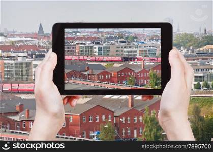 travel concept - tourist taking photo of Copenhagen skyline on mobile gadget, Denmark