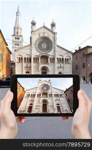 travel concept - tourist taking photo of Modena Cathedral on mobile gadget, Italy