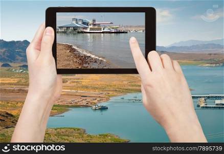 travel concept - tourist taking photo of recreation area on Lake Mead on mobile gadget, Nevada, USA