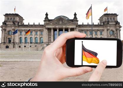 travel concept - tourist taking photo of Reichstag Building on mobile gadget, Berlin, Germany