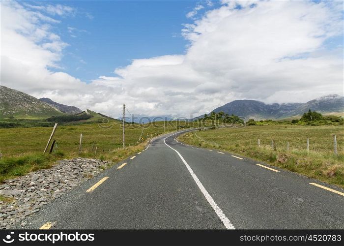 travel, drive, landscape and countryside concept - asphalt road at connemara in ireland