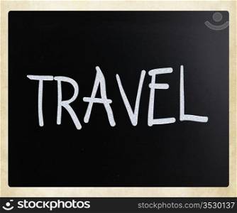 ""Travel" handwritten with white chalk on a blackboard."