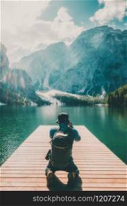 Travel hiker taking photo of Lake Braies (Lago di Braies) in Dolomites Mountains, Italy. Hiking travel and adventure.