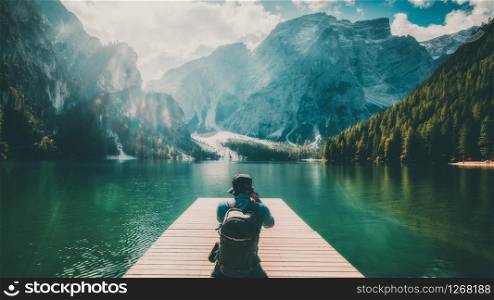 Travel hiker taking photo of Lake Braies (Lago di Braies) in Dolomites Mountains, Italy. Hiking travel and adventure.