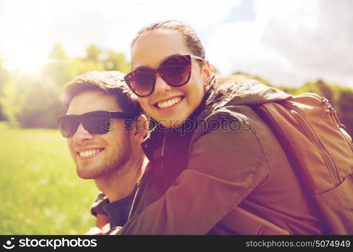 travel, hiking, backpacking, tourism and people concept - happy couple in sunglasses with backpacks having fun outdoors. happy couple with backpacks having fun outdoors