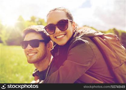 travel, hiking, backpacking, tourism and people concept - happy couple in sunglasses with backpacks having fun outdoors. happy couple with backpacks having fun outdoors