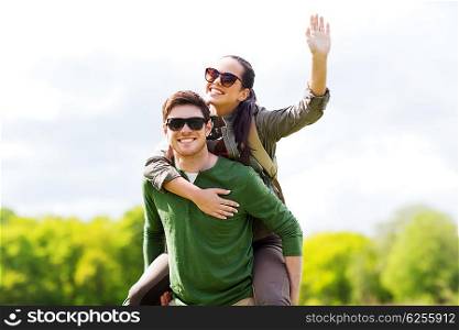 travel, hiking, backpacking, tourism and people concept - happy couple in sunglasses with backpacks having fun and waving hand outdoors