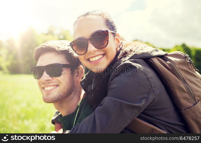 travel, hiking, backpacking, tourism and people concept - happy couple in sunglasses with backpacks having fun outdoors. happy couple with backpacks having fun outdoors. happy couple with backpacks having fun outdoors