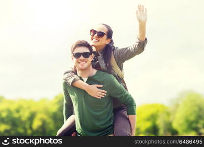 travel, hiking, backpacking, tourism and people concept - happy couple in sunglasses with backpacks having fun and waving hand outdoors. happy couple with backpacks having fun outdoors. happy couple with backpacks having fun outdoors