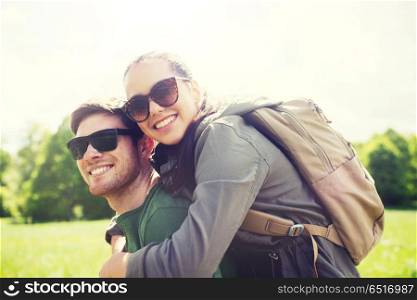 travel, hiking, backpacking, tourism and people concept - happy couple in sunglasses with backpacks having fun outdoors. happy couple with backpacks having fun outdoors. happy couple with backpacks having fun outdoors