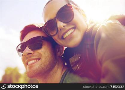 travel, hiking, backpacking, tourism and people concept - happy couple in sunglasses having fun outdoors. happy couple having fun outdoors