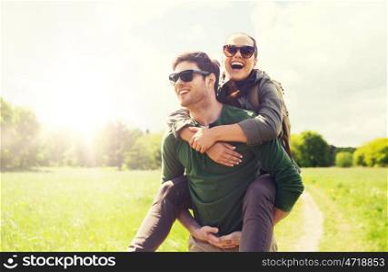 travel, hiking, backpacking, tourism and people concept - happy couple with backpacks having fun and walking along country road outdoors. happy couple with backpacks having fun outdoors. happy couple with backpacks having fun outdoors