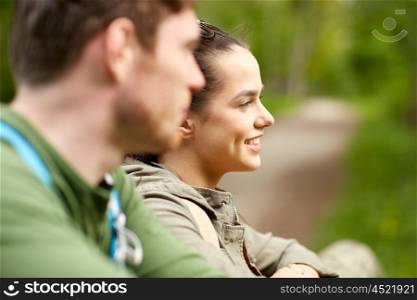 travel, hiking, backpacking, tourism and people concept - smiling couple with backpacks in nature