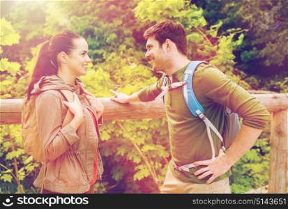 travel, hiking, backpacking, tourism and people concept - smiling couple with backpacks in nature. smiling couple with backpacks in nature